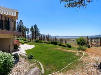 Enjoy breathtaking lake and mountain views from this stunning property, featuring a spacious deck perfect for entertaining.