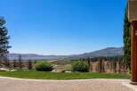 Experience breathtaking panoramic views of a serene lake and majestic mountains from this stunning property.