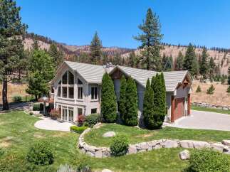 Experience luxury living in this stunning home, featuring expansive windows that flood the interior with natural light and offer breathtaking views of the surrounding landscape.