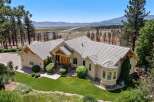 Experience luxury living in this stunning custom-built home offering breathtaking panoramic views of the lake and mountains.