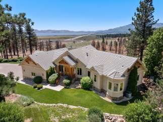Experience luxury living in this stunning custom-built home offering breathtaking panoramic views of the lake and mountains.