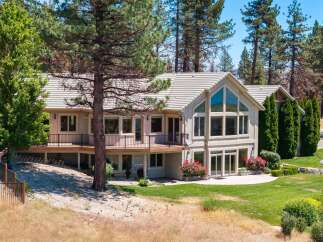 Nestled amidst towering pine trees, this stunning multi-level home offers breathtaking views and abundant natural light.