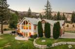 Experience luxury living in this stunning mountain home, featuring expansive windows that flood the interior with natural light and offer breathtaking views of the surrounding landscape.