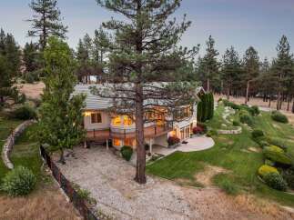 Experience luxury living in this stunning multi-level home nestled amidst a serene pine forest.
