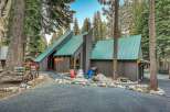 Experience mountain living in this charming A-frame cabin nestled amongst tall pine trees.