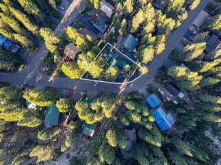 Discover this charming property nestled amongst tall trees, offering a private and serene mountain retreat.