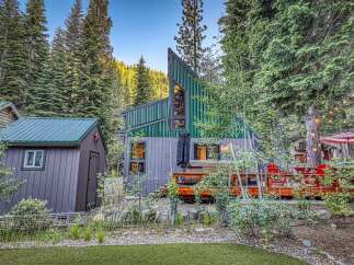 Nestled amidst a serene forest, this unique A-frame cabin offers a tranquil retreat.