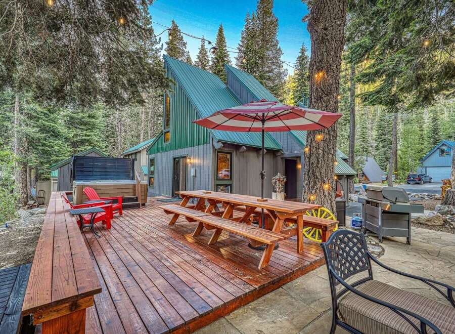 Experience the ultimate mountain getaway with this stunning property featuring a spacious wooden deck, perfect for outdoor entertaining.