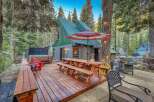 Experience the ultimate mountain getaway with this stunning property featuring a spacious wooden deck, perfect for outdoor entertaining.