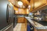 Experience rustic charm in this cozy kitchen, featuring warm oak cabinetry and elegant granite countertops.