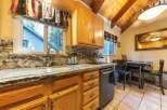 This charming kitchen boasts beautiful granite countertops and warm oak cabinetry, creating a cozy and inviting atmosphere.
