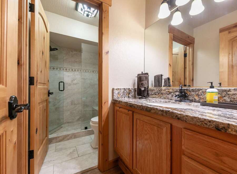 This charming bathroom features a spacious walk-in shower with elegant tilework and a convenient toilet.