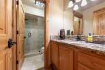 This charming bathroom features a spacious walk-in shower with elegant tilework and a convenient toilet.