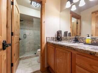 This charming bathroom features a spacious walk-in shower with elegant tilework and a convenient toilet.