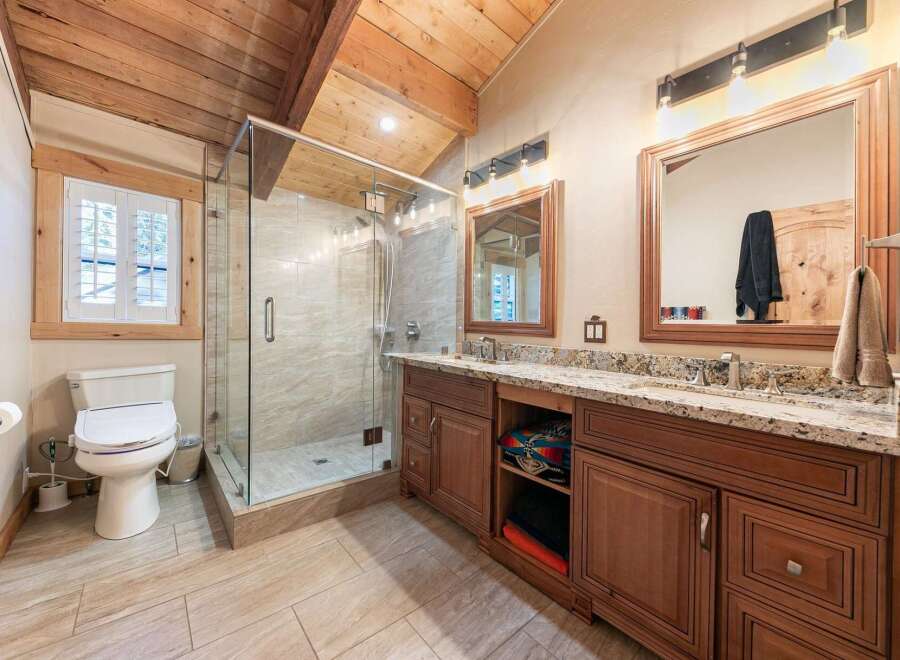 Experience luxury in this stunning bathroom featuring a spacious glass-enclosed shower with elegant tilework.