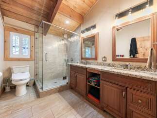 Experience luxury in this stunning bathroom featuring a spacious glass-enclosed shower with elegant tilework.