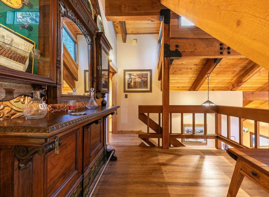 Step into a rustic lodge-style home featuring a stunning wooden bar and intricate detailing.