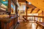 Step into a rustic lodge-style home featuring a stunning wooden bar and intricate detailing.
