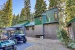 Discover this unique mountain retreat featuring a modern architectural design with striking green metal siding and a complementary gray wood exterior.