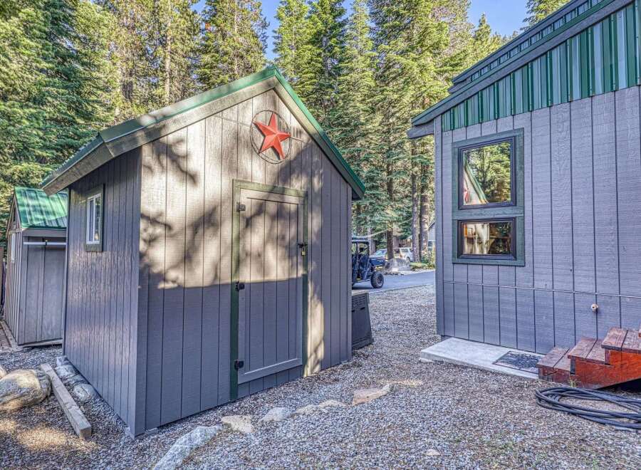 Discover this charming property featuring a rustic shed with a decorative star, perfect for storage or a creative space.