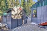 Discover this charming property featuring a rustic shed with a decorative star, perfect for storage or a creative space.
