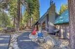 Nestled amidst towering pine trees, this charming property offers a serene mountain retreat.
