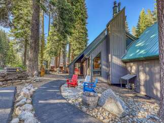 Nestled amidst towering pine trees, this charming property offers a serene mountain retreat.