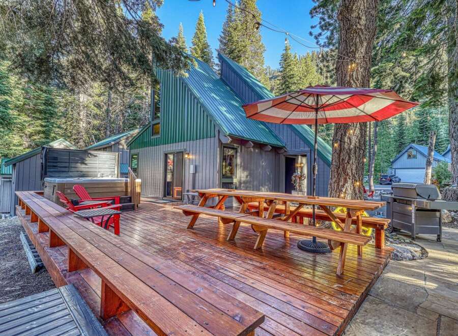 Experience the ultimate mountain getaway with this stunning property featuring a luxurious hot tub and expansive wooden deck perfect for outdoor entertaining.
