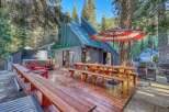 Experience the ultimate mountain getaway with this stunning property featuring a luxurious hot tub and expansive wooden deck perfect for outdoor entertaining.