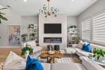 Experience modern living in this stunning living room, featuring a sleek fireplace and a large flat-screen TV as the focal point.