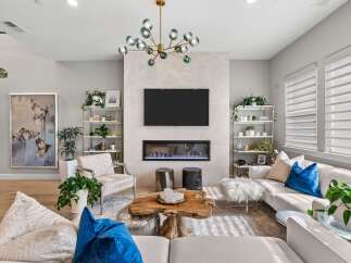 Experience modern living in this stunning living room, featuring a sleek fireplace and a large flat-screen TV as the focal point.