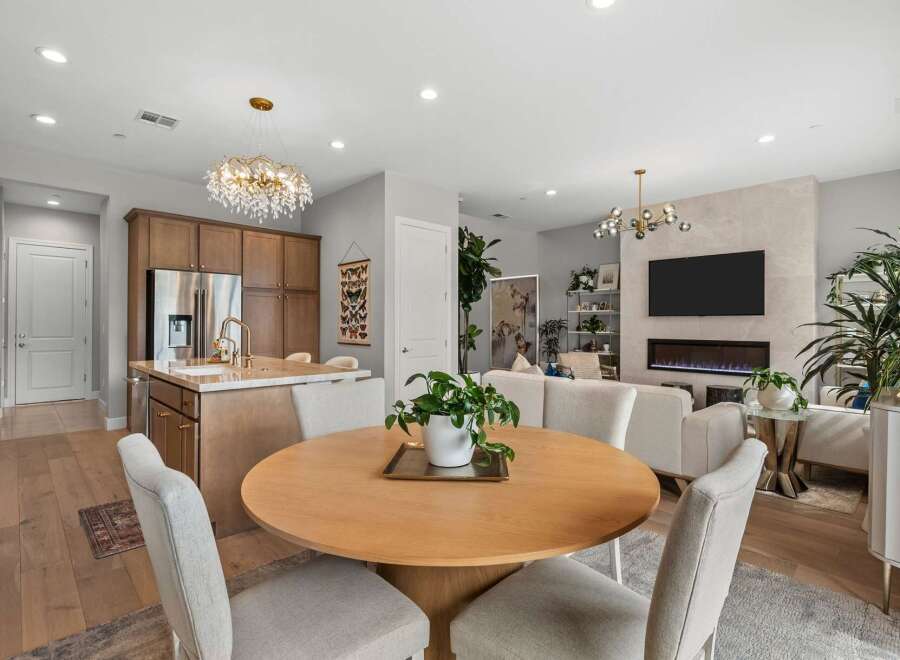 Experience modern living in this open-concept space featuring a gourmet kitchen with a large island and sleek cabinetry.