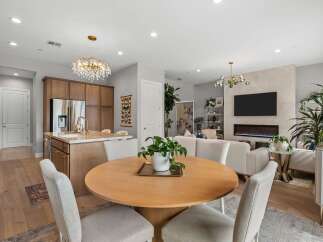 Experience modern living in this open-concept space featuring a gourmet kitchen with a large island and sleek cabinetry.