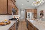 Experience luxury in this stunning kitchen featuring sleek, modern cabinetry and a spacious island with a farmhouse sink.