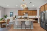 Experience luxury living in this stunning kitchen featuring elegant wood cabinetry and a spacious marble island perfect for entertaining.