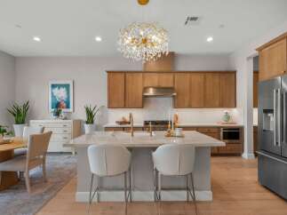 Experience luxury living in this stunning kitchen featuring elegant wood cabinetry and a spacious marble island perfect for entertaining.