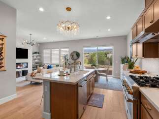Experience modern living in this stunning open-concept home, featuring a gourmet kitchen with a large island and top-of-the-line appliances.