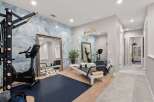 Transform your wellness routine in this dedicated home gym, featuring a high-end stationary bike and a Pilates reformer.