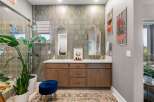 This stunning bathroom features a spacious double vanity with elegant gold-framed mirrors and modern brass fixtures.