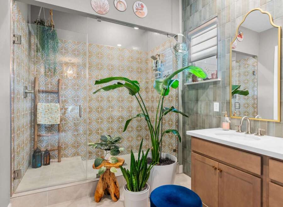This stunning bathroom features a spacious walk-in shower with intricate patterned tiles, creating a spa-like atmosphere.