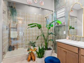 This stunning bathroom features a spacious walk-in shower with intricate patterned tiles, creating a spa-like atmosphere.
