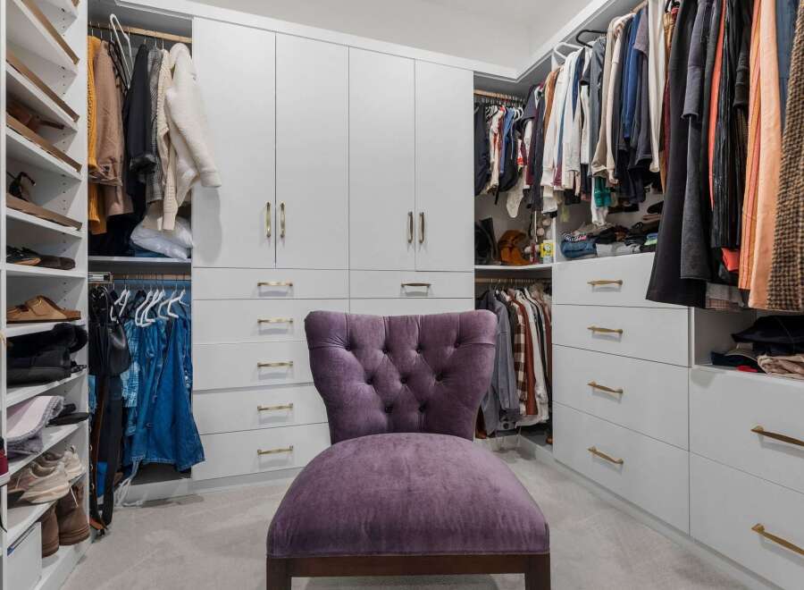 Step into this luxurious walk-in closet, designed for ultimate organization and style.