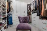 Step into this luxurious walk-in closet, designed for ultimate organization and style.