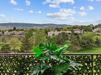 Enjoy breathtaking views from this property, overlooking a lush golf course and rolling hills.