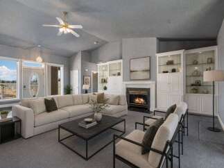 Step into this inviting living room, featuring a spacious sectional sofa perfect for gatherings and a cozy fireplace for warm evenings.