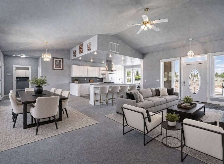 Experience open-concept living in this stunning home, featuring a spacious dining area perfect for gatherings and a modern kitchen with ample counter space and bar seating.