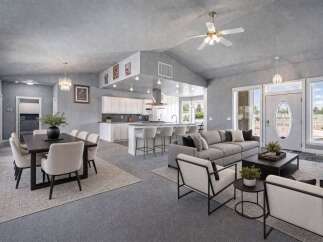 Experience open-concept living in this stunning home, featuring a spacious dining area perfect for gatherings and a modern kitchen with ample counter space and bar seating.