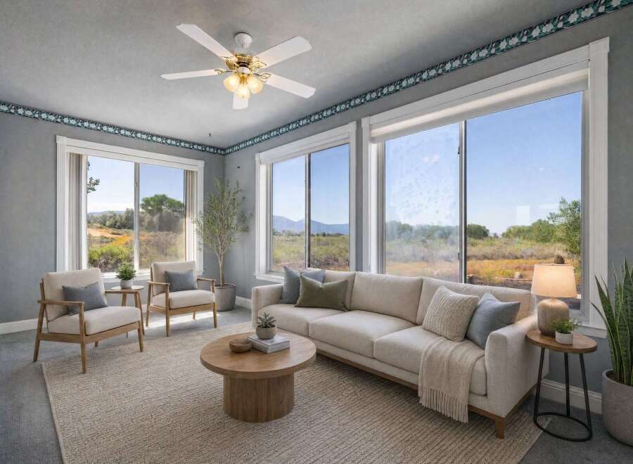 Experience breathtaking natural beauty from this living room, featuring expansive windows that showcase stunning landscape views.