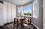 Enjoy your morning coffee in this charming breakfast nook, bathed in natural light from the large bay windows.
