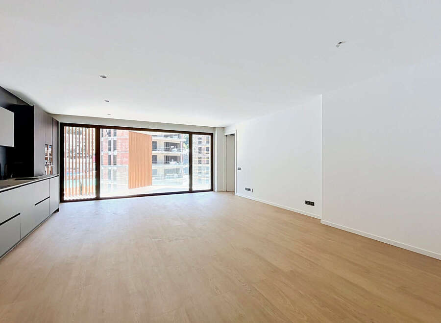 Experience modern living in this spacious, light-filled apartment featuring a sleek, integrated kitchen with ample cabinet space.